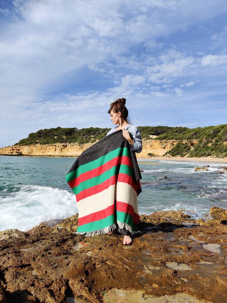 Hand woven cloth in green red and natural black striped new wool