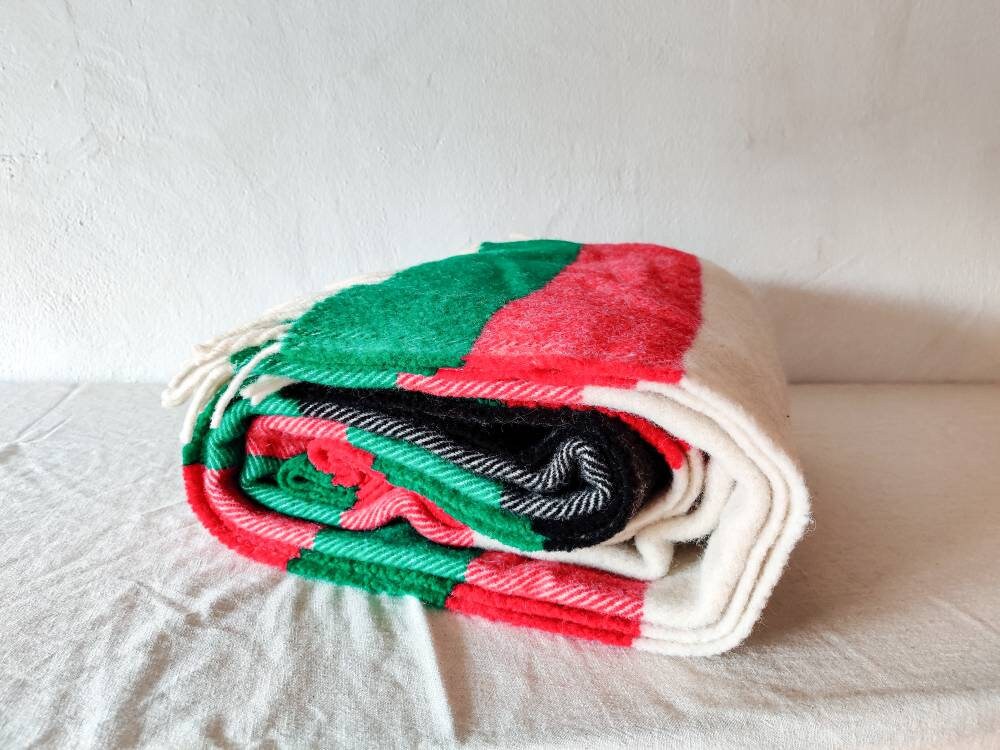 Hand woven cloth in green red and natural black striped new wool